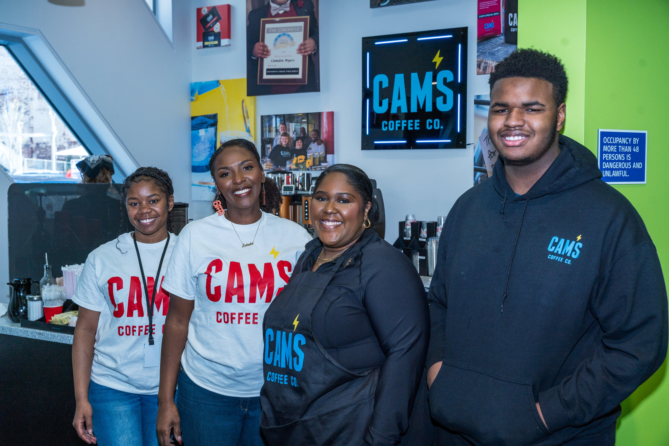 Cam's Coffee team standing together in the café