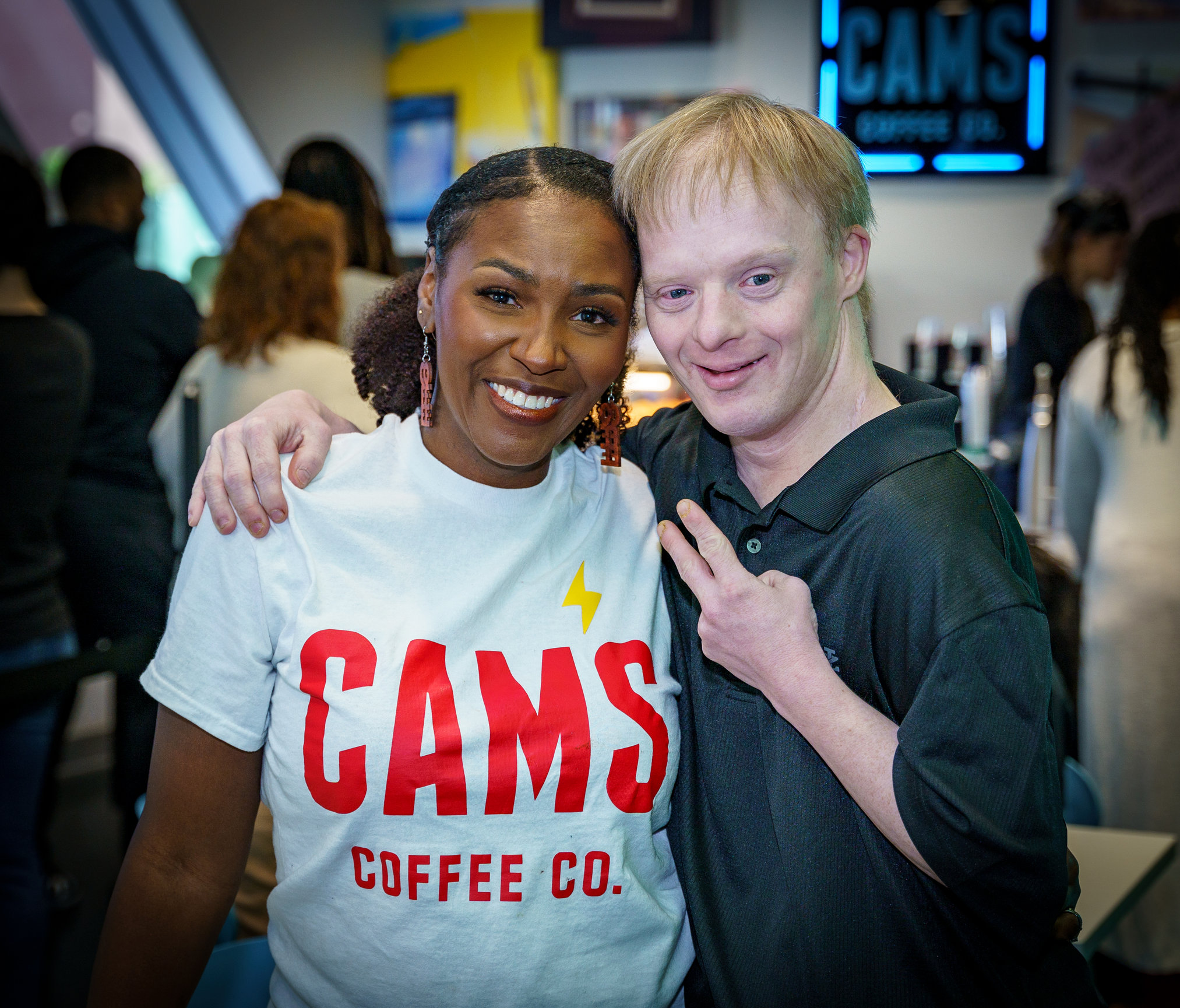 Latasha with a community member inside Cam's Coffee